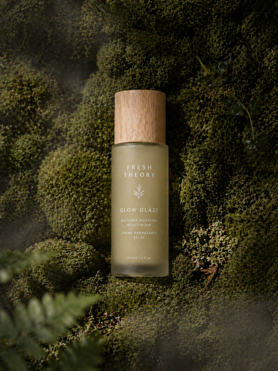 flacon de soin hydratant Fresh Theory posé sur de la mousse naturelle, illustrant une clean beauty inspirée de la nature et respectueuse de la peau
